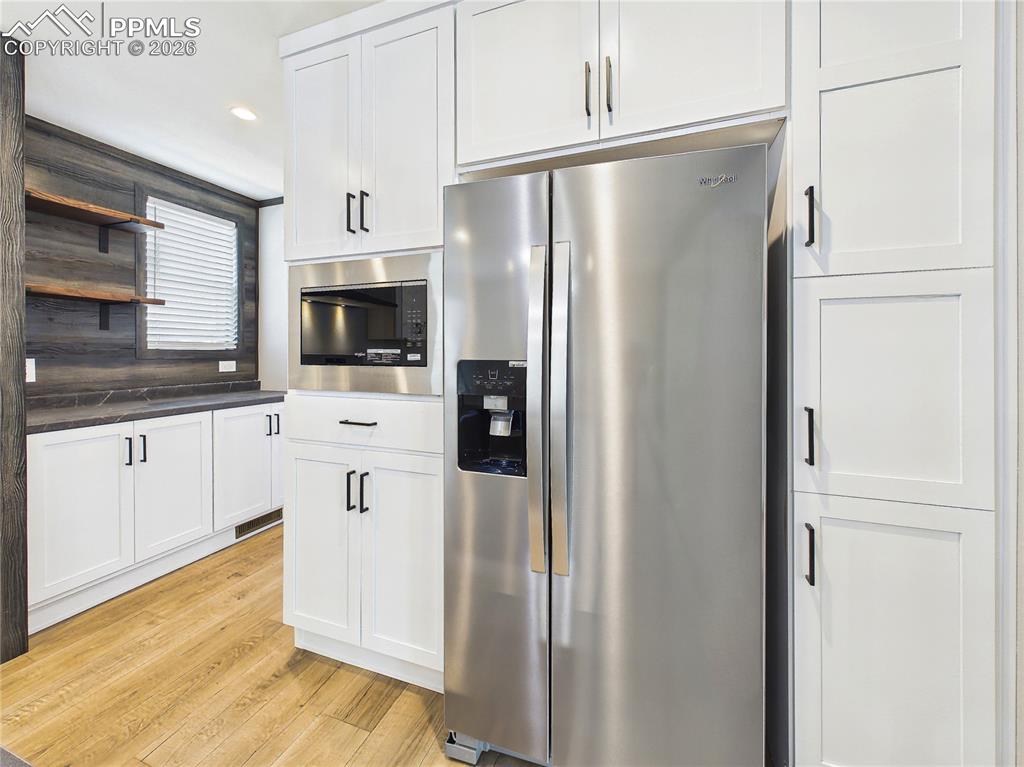 Image 19 of 50: Kitchen – Range Wall (Angle) – Clean, modern design with ample counter spac