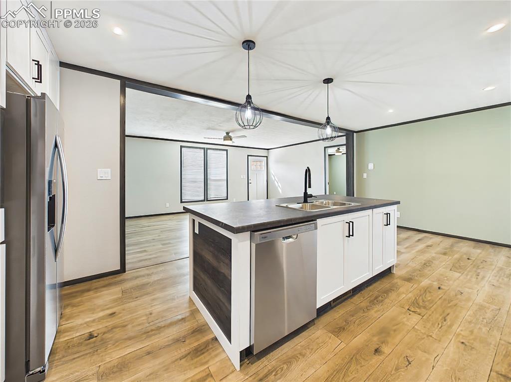 Image 21 of 50: Kitchen – Stylish open-concept kitchen featuring a large island with seatin