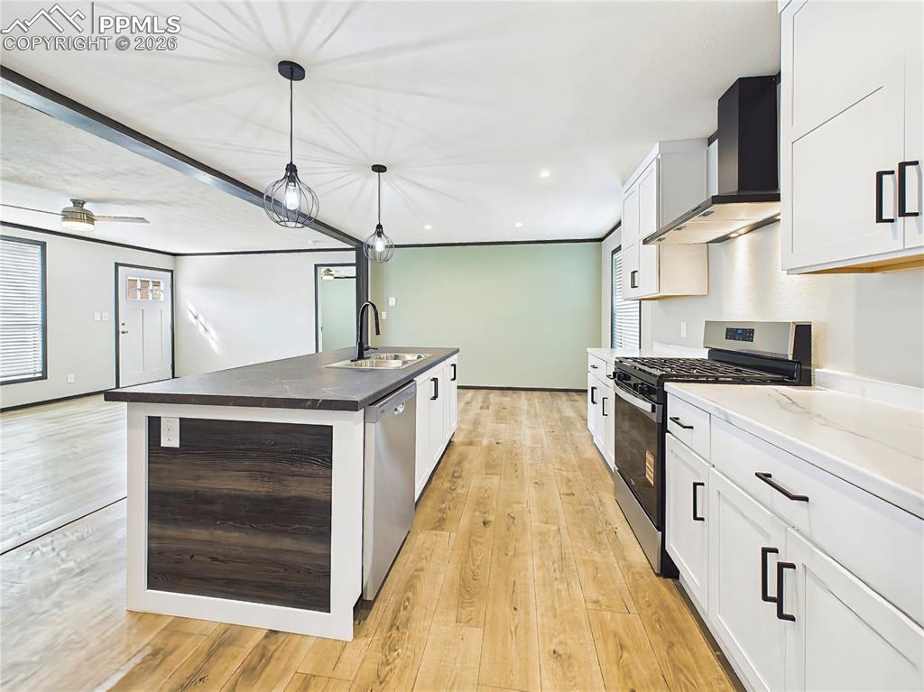 Image 24 of 50: Kitchen – Open-concept kitchen featuring a large island with seating, moder