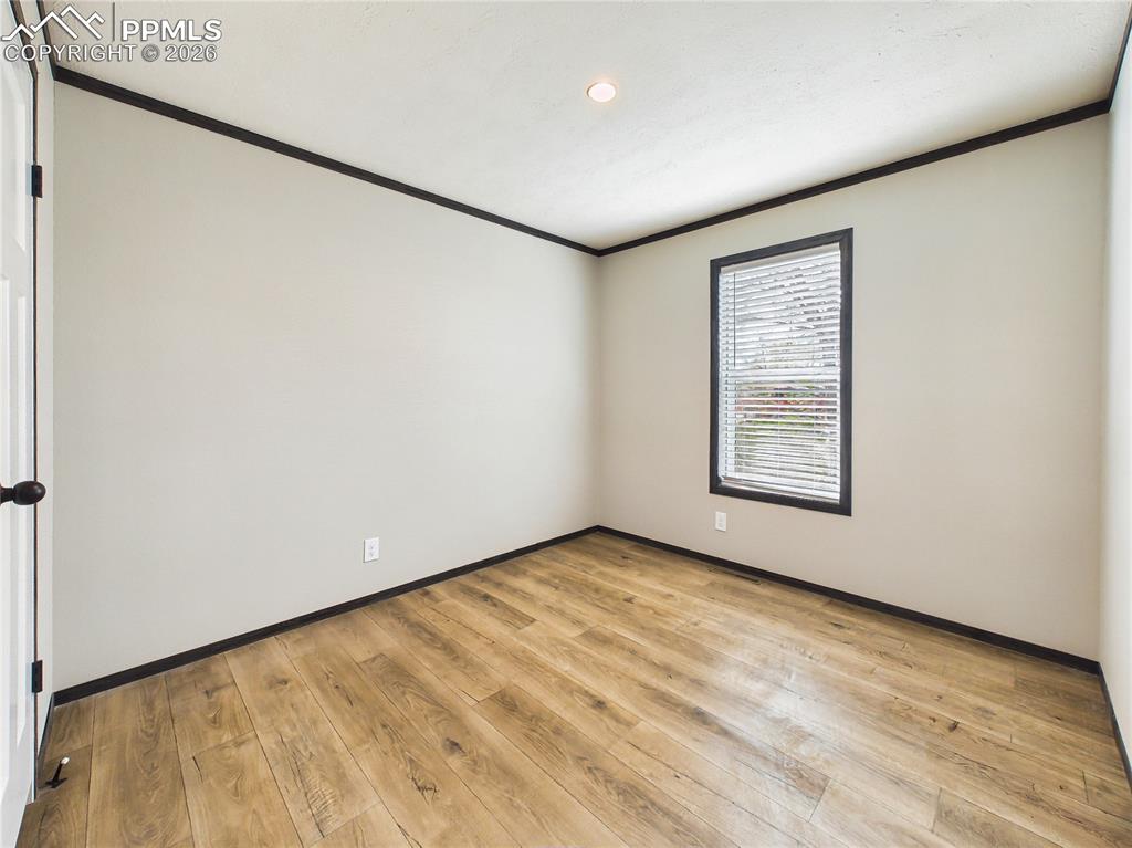 Image 36 of 50: Bedroom 2 – Bright and versatile bedroom with wide-plank flooring, neutral