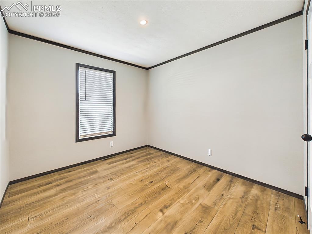 Image 38 of 50: Bedroom 3– Bright and versatile bedroom with wide-plank flooring, neutral t