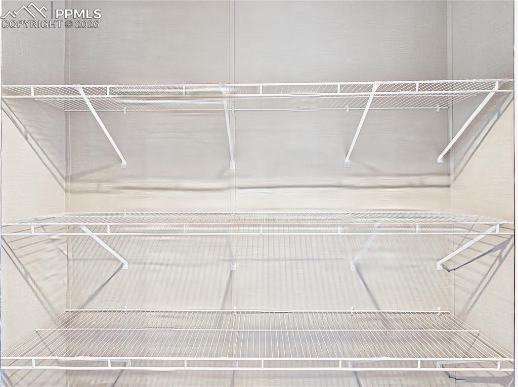 Image 43 of 50: Walk-In Closet – Generous walk-in closet with multiple shelving tiers, prov