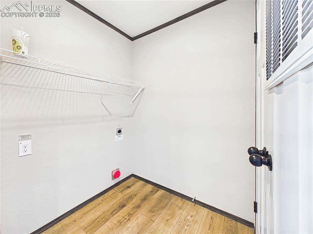 Image 44 of 50: Laundry Area – Functional laundry space with shelving and room for applianc