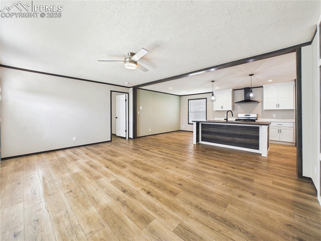 Image 7 of 50: Living Area – Spacious living area with an open layout, updated flooring, a