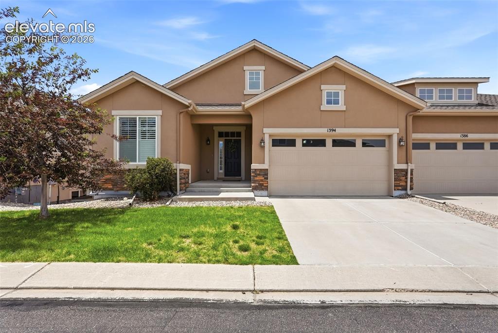 Image 1 of 47: Stucco exterior featuring stone accents, an attached two-car garage, and a 