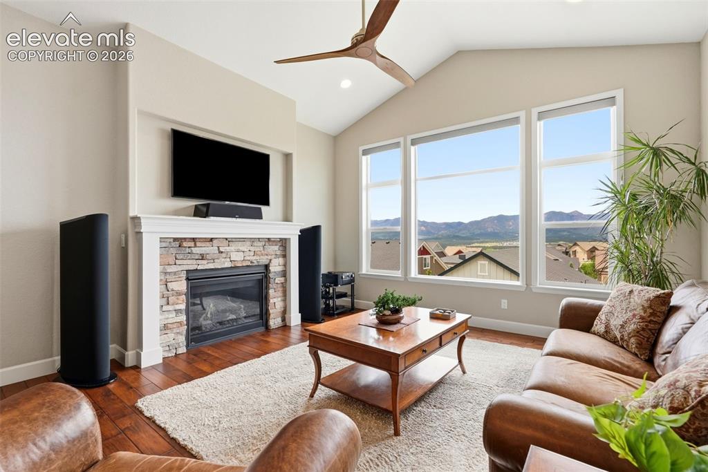 Image 15 of 47: Living area featuring a vaulted ceiling and an integrated ceiling fan