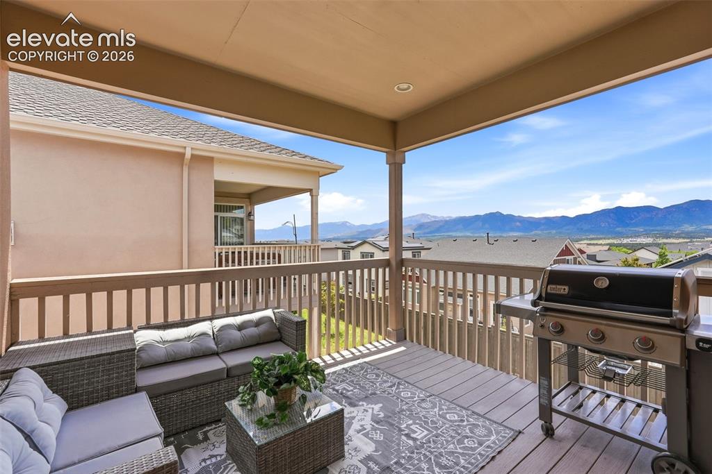 Image 18 of 47: Covered outdoor deck with mountain scenery