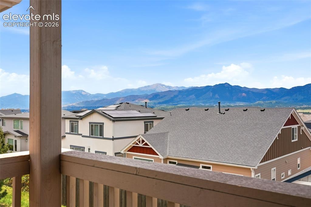 Image 19 of 47: Balcony offering a mountain backdrop under a clear sky