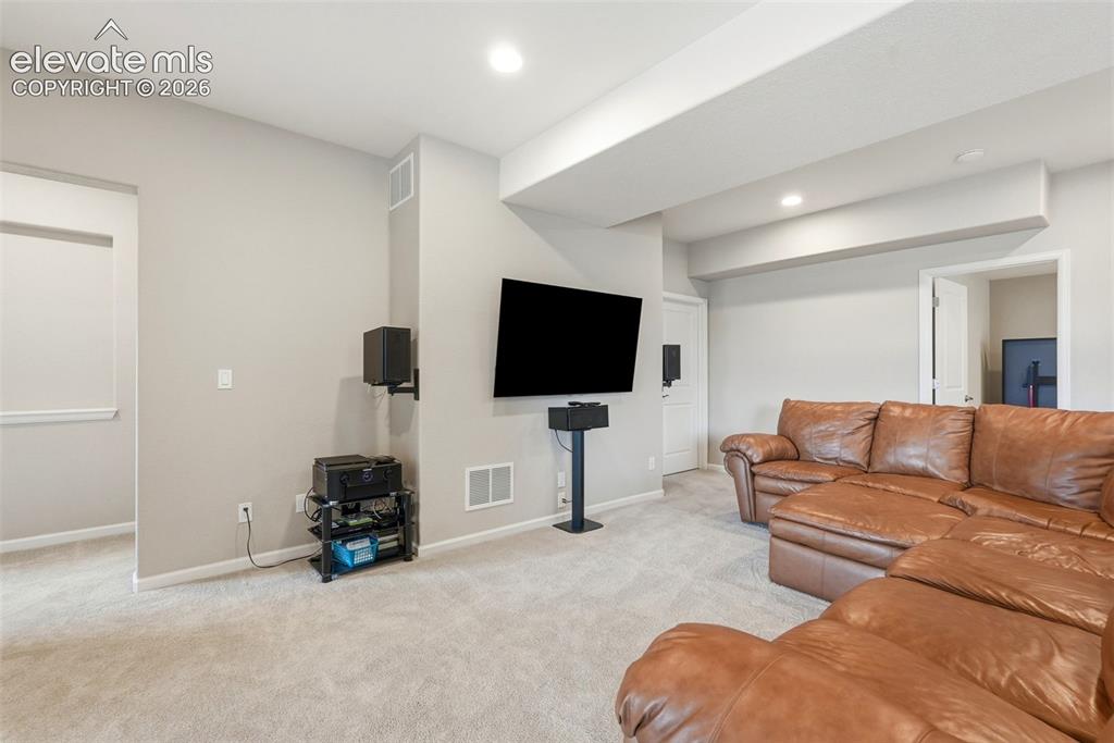 Image 35 of 47: Carpeted entertainment area featuring recessed lighting and light gray wall
