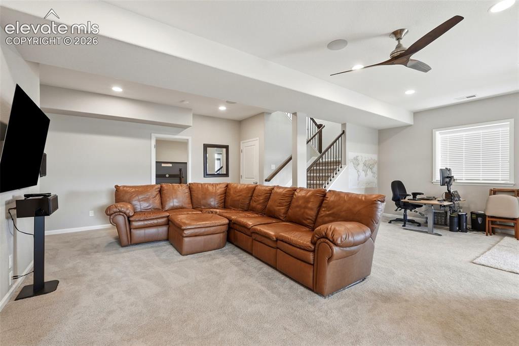Image 36 of 47: Spacious carpeted recreation area featuring recessed lighting, a modern cei
