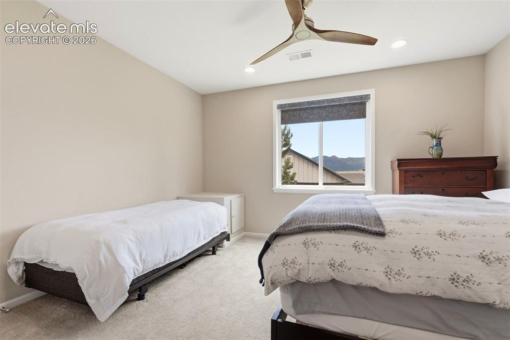 Image 41 of 47: Carpeted room featuring a white-framed window with roller shades, recessed 