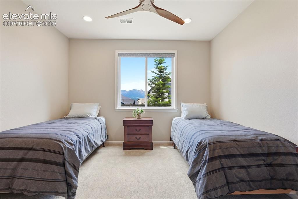 Image 45 of 47: Carpeted room with a rectangular window, recessed lighting, and a modern ce