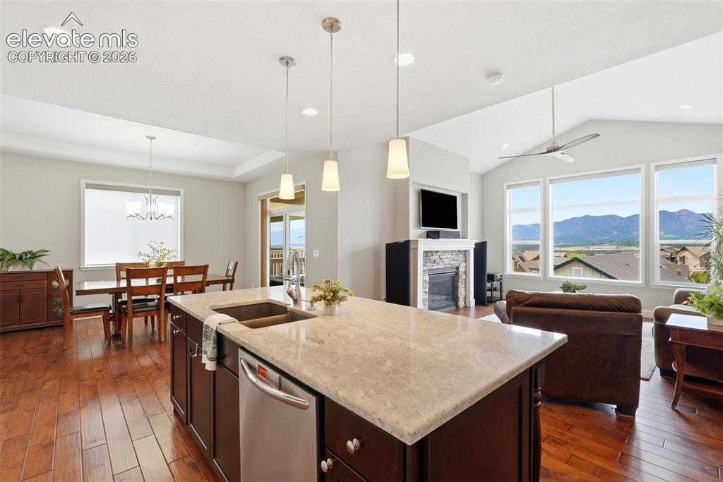 Image 9 of 47: Kitchen island with an undermount sink and a stainless steel dishwasher
