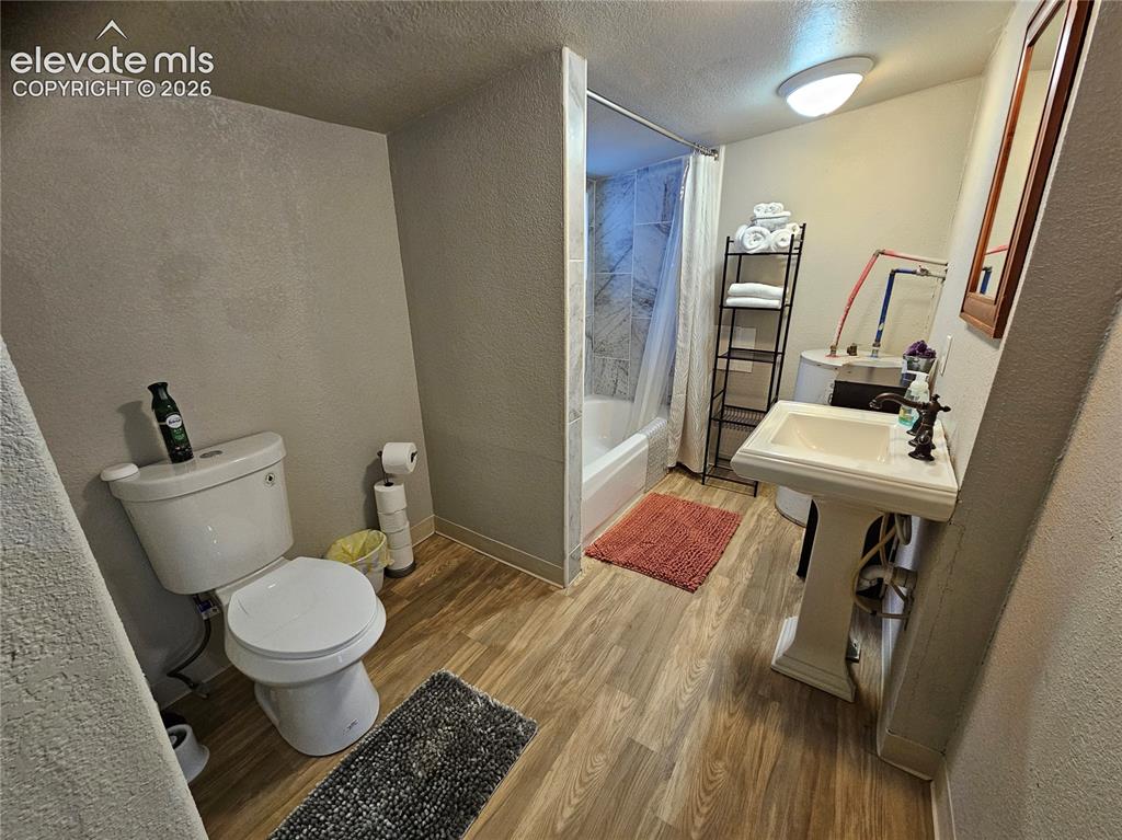 Image 8 of 39: Unit B bathroom and water heater