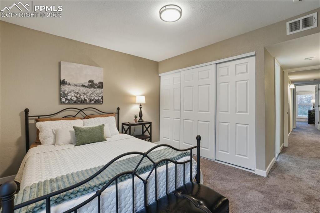 Image 11 of 25: Bedroom with carpet and a closet