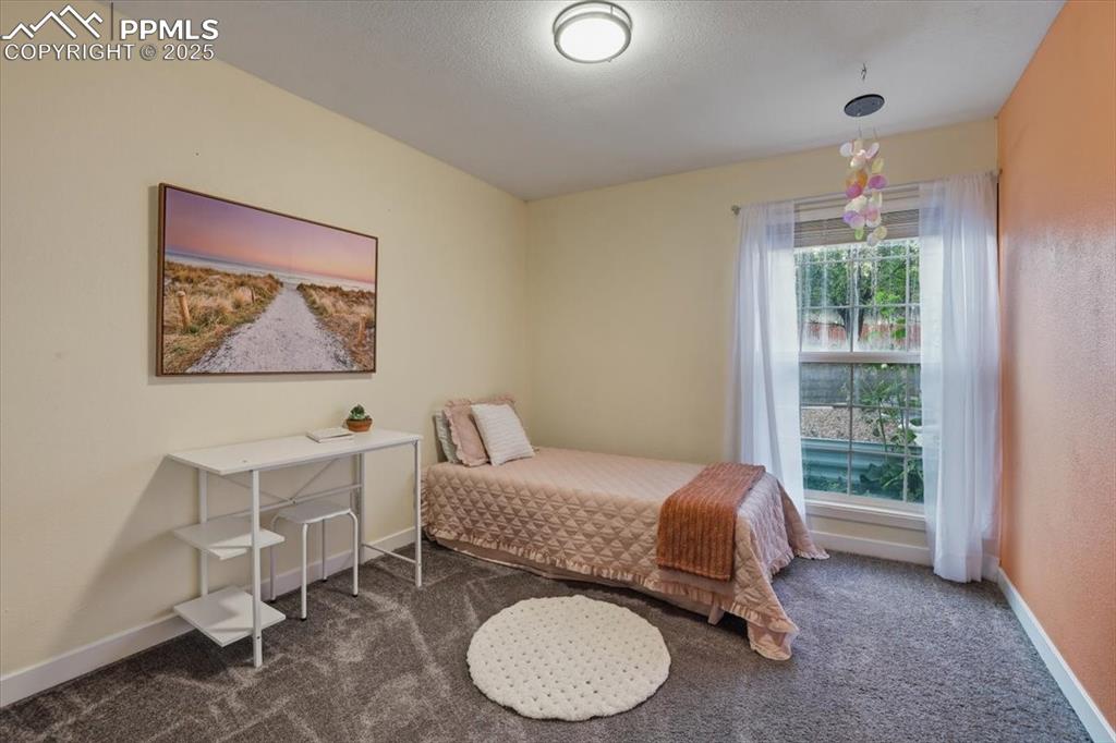 Image 13 of 25: Bedroom featuring carpet floors and a textured ceiling