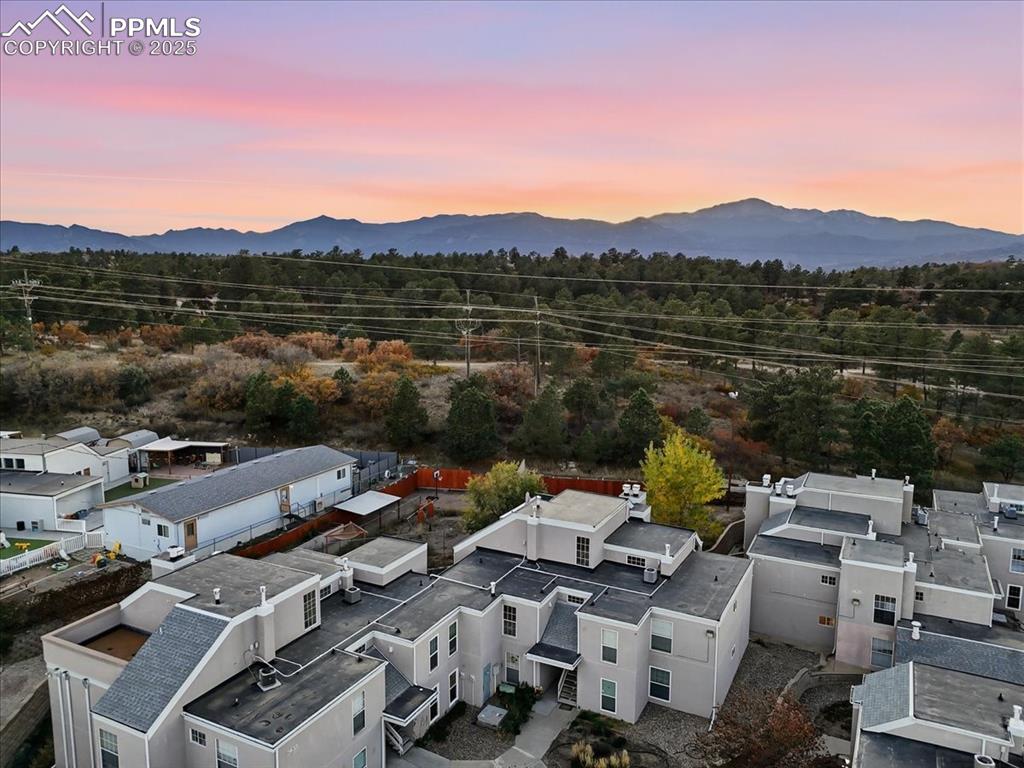 Image 22 of 25: Aerial view at dusk of a mountain view and a residential view
