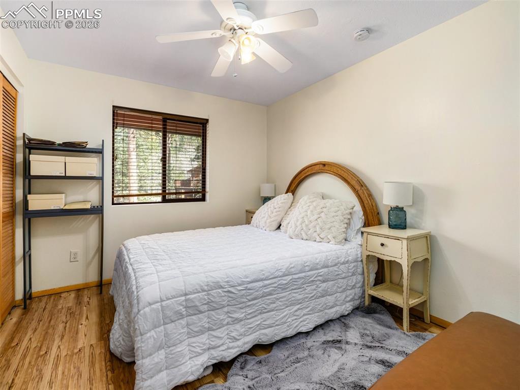 Image 16 of 37: Bedroom with wood finished floors, ceiling fan, and a closet