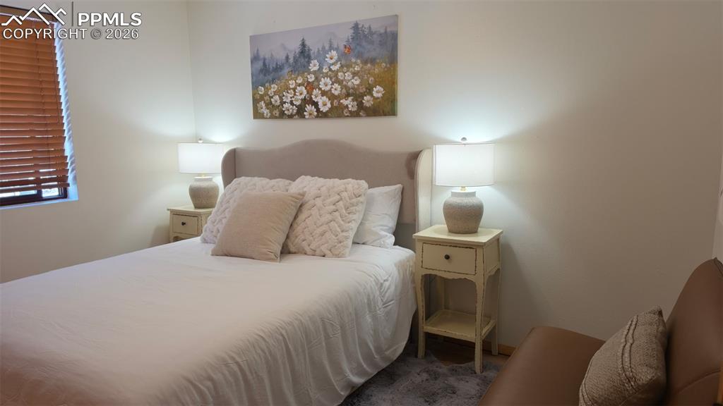 Image 17 of 38: Room featuring neutral wall tones, a window with wood blinds, and a built-i