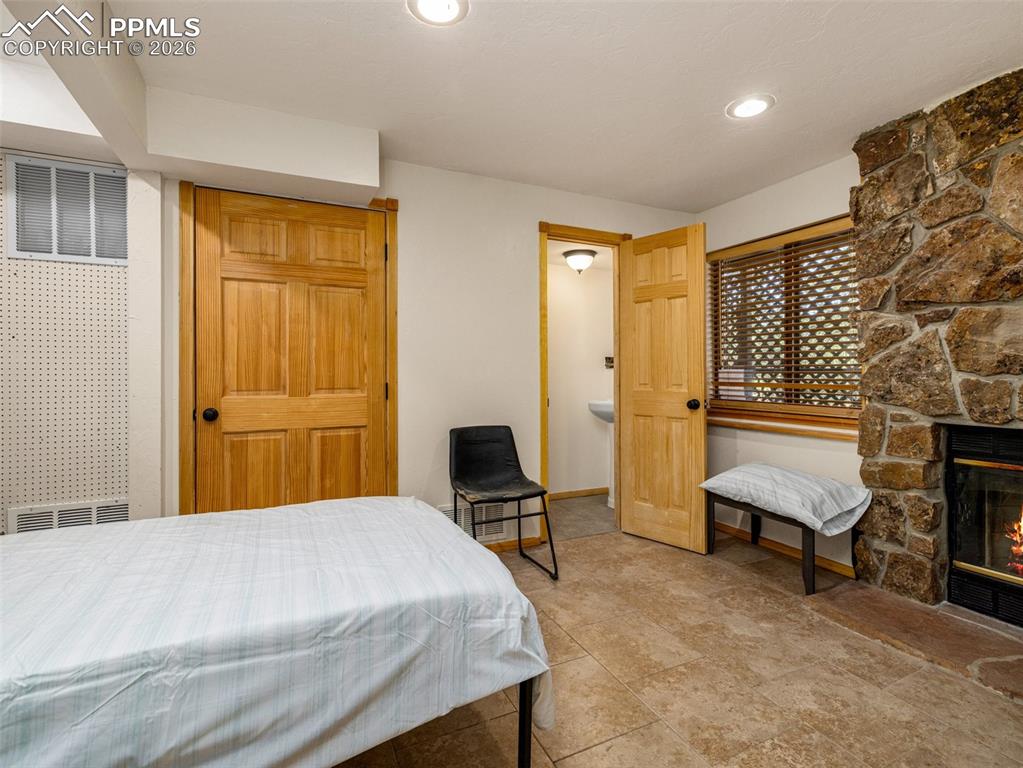 Image 19 of 37: Bedroom featuring a fireplace and a closet