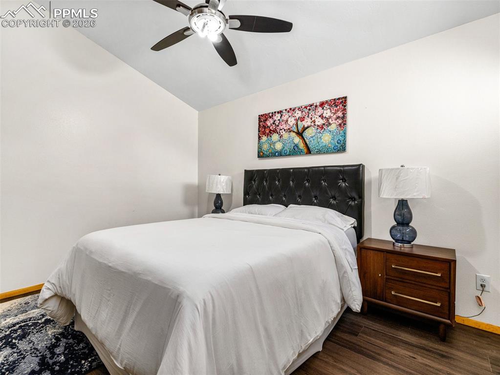 Image 22 of 38: Bedroom featuring a ceiling fan and dark wood-style floors