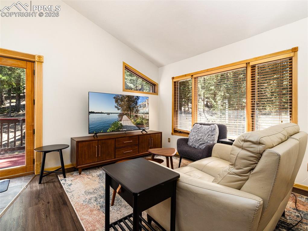 Image 24 of 38: Living room featuring lofted ceiling and wood finished floors