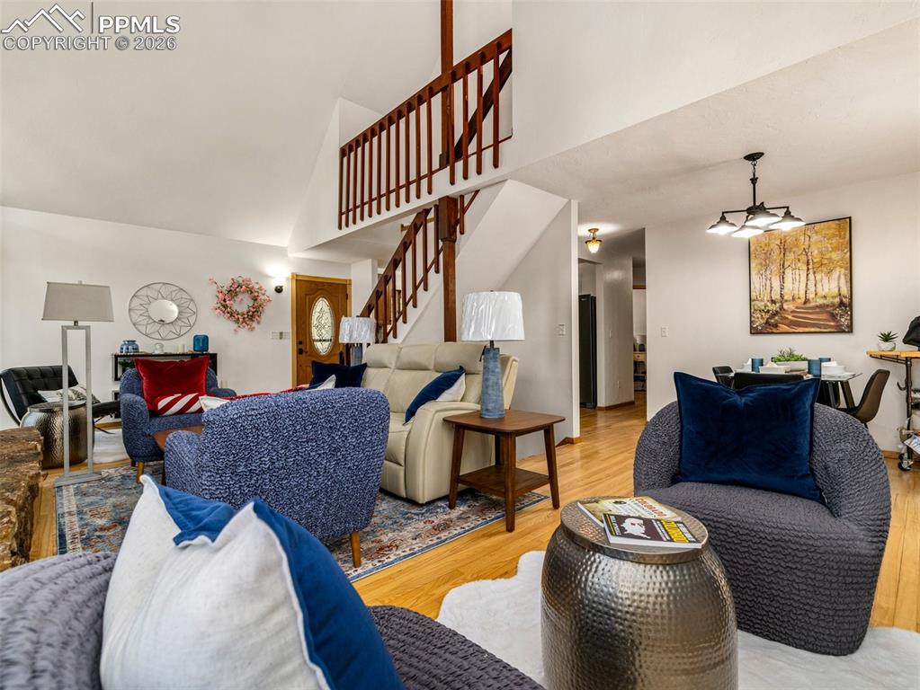 Image 9 of 37: Living room featuring light wood-style flooring and lofted ceiling