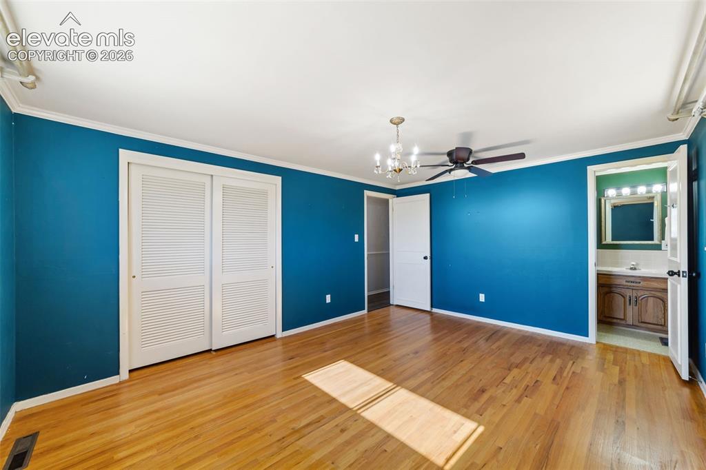 Image 15 of 50: Spacious room featuring wood-finish flooring and a ceiling fan