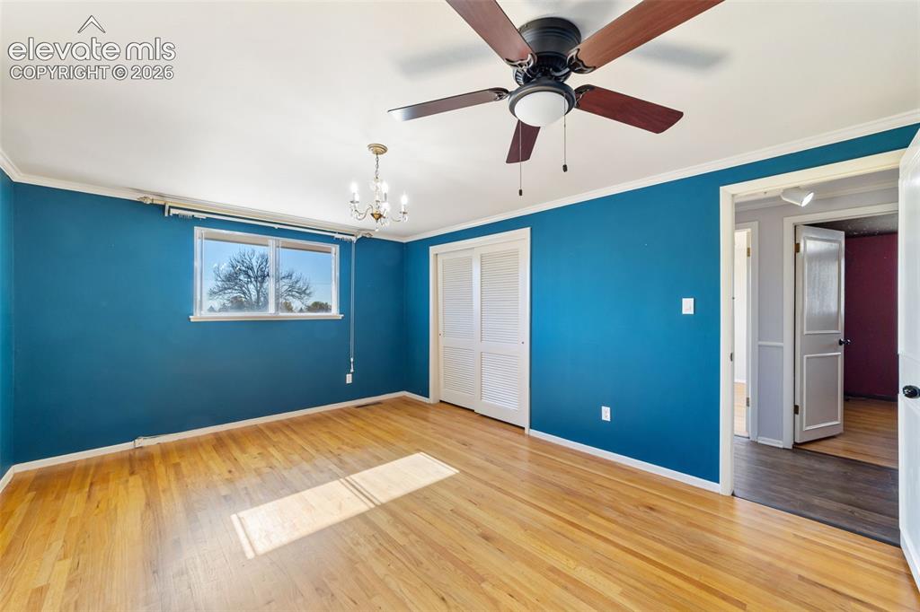 Image 17 of 50: Hardwood flooring throughout featuring white baseboards, a ceiling fan with