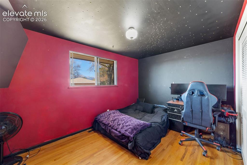 Image 23 of 50: Room featuring wood-finish flooring, a window with exterior scenery, a blac