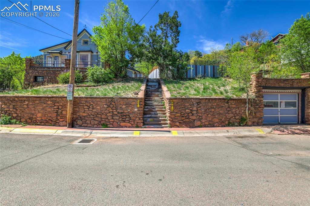 Image 32 of 44: Dedicated garage space on the right. Resident parking on street with permit