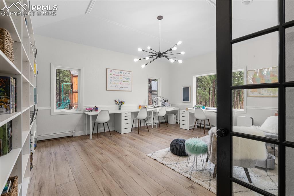 Image 10 of 47: The main level office is adjacent to the living room and features built ins