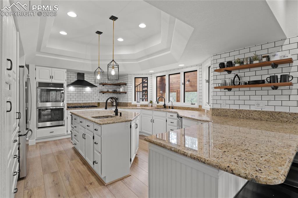 Image 15 of 47: The kitchen features pendant lighting, ample storage and prep space, double