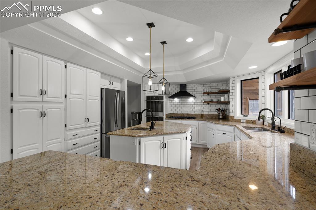 Image 16 of 47: The kitchen is large and flows with the rest of the house to create an invi