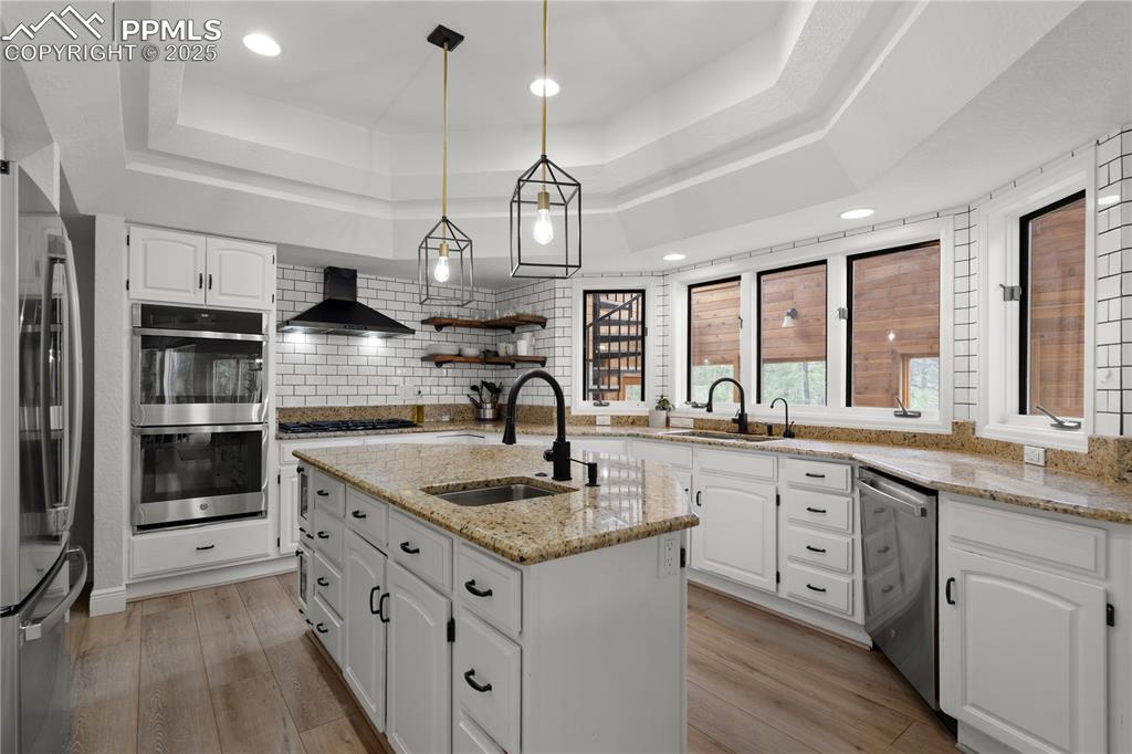 Image 17 of 47: This kirchen feautires granite counters, double ovens and new appliances al