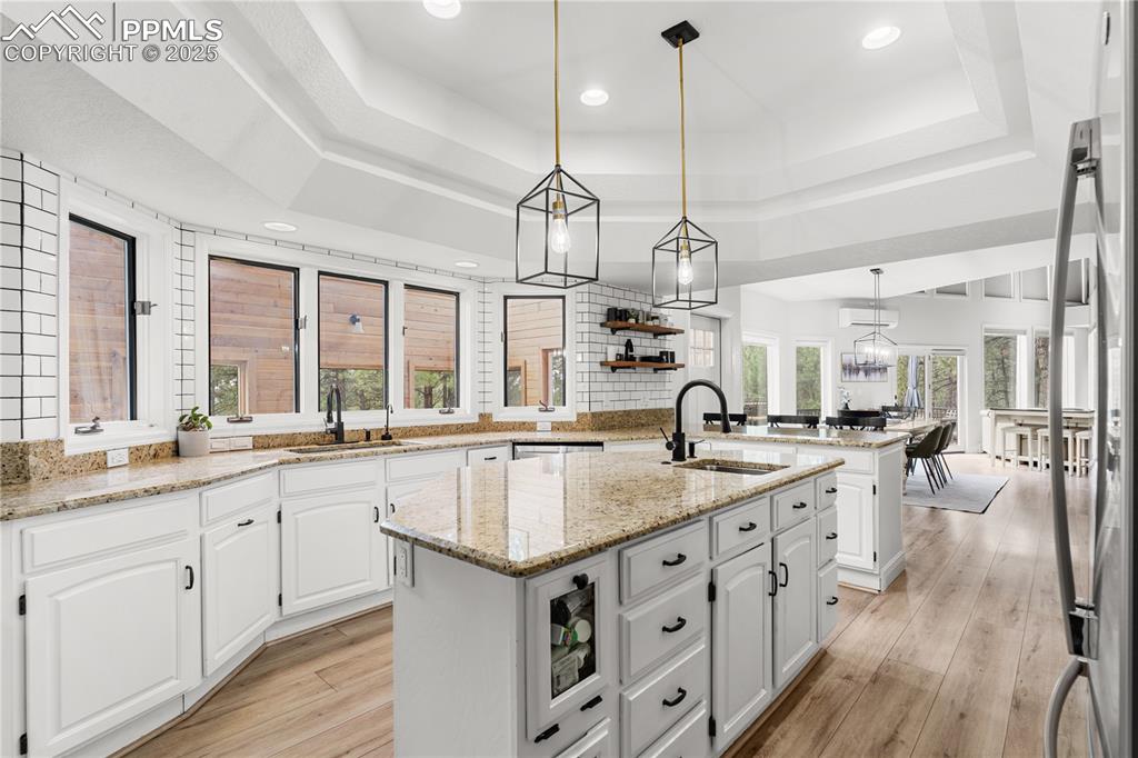 Image 18 of 47: A modern kitchen with anple storage , gleaming subway tile and everything y