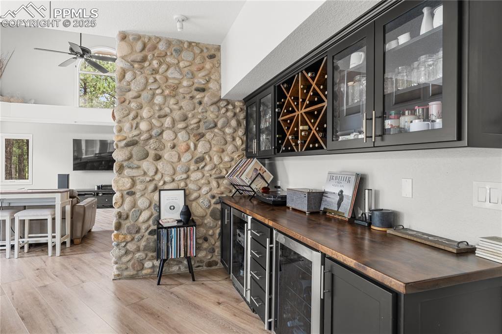 Image 19 of 47: The bar area offers additional storage space with a separate beverage fridg