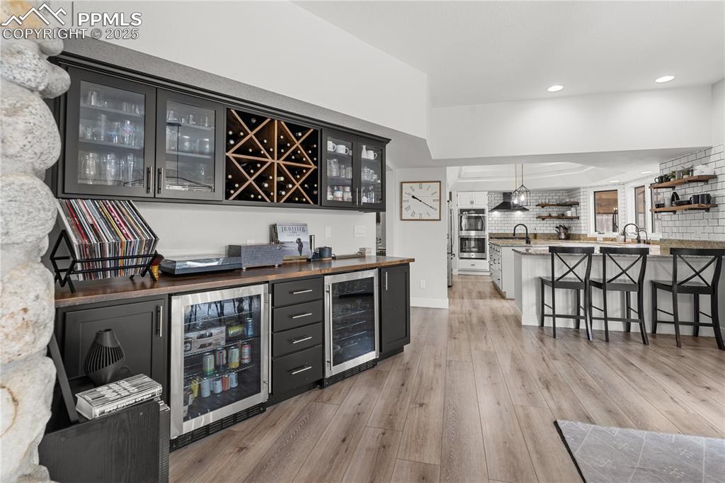 Image 20 of 47: The bar, off of the living room is the perfect addition to any event you ho