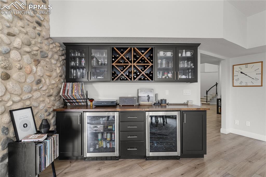 Image 21 of 47: The bar near the kitchen has the warm of the stone wall with the convenienc