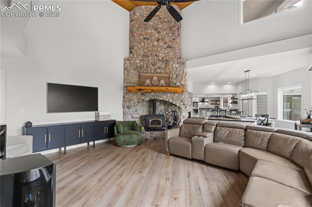 Image 23 of 47: With luxury vinyl flooring and soaring ceilings, this living room feels inv
