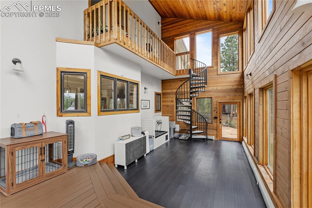 Image 25 of 47: The sunroom, aptly named for the bountiful views and natural light allows y