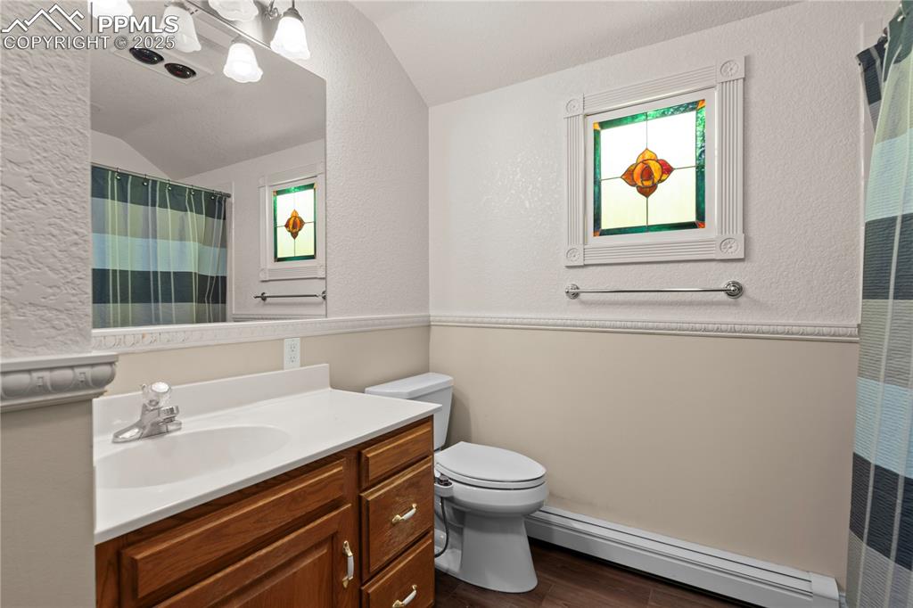 Image 33 of 47: Well lit bathroom with stone counters