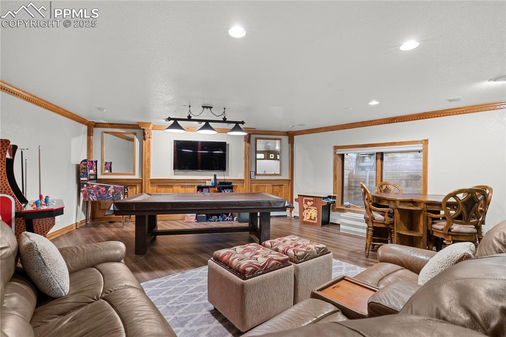Image 38 of 47: Basement game room with luxury flooring