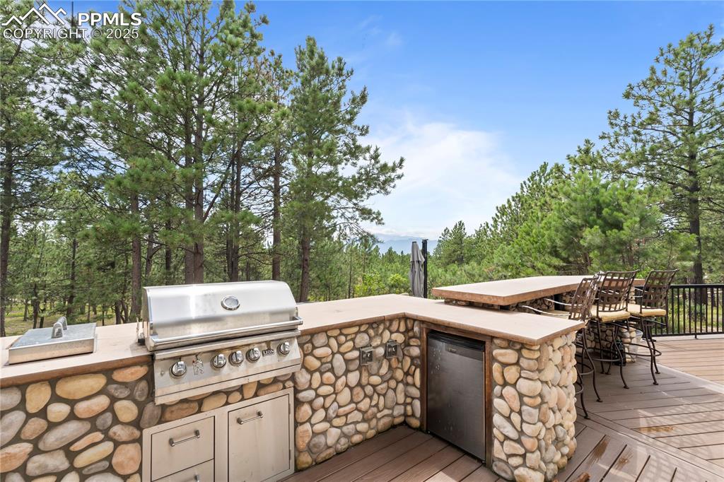 Image 6 of 47: Upper patio with grill, counters and refrigerator