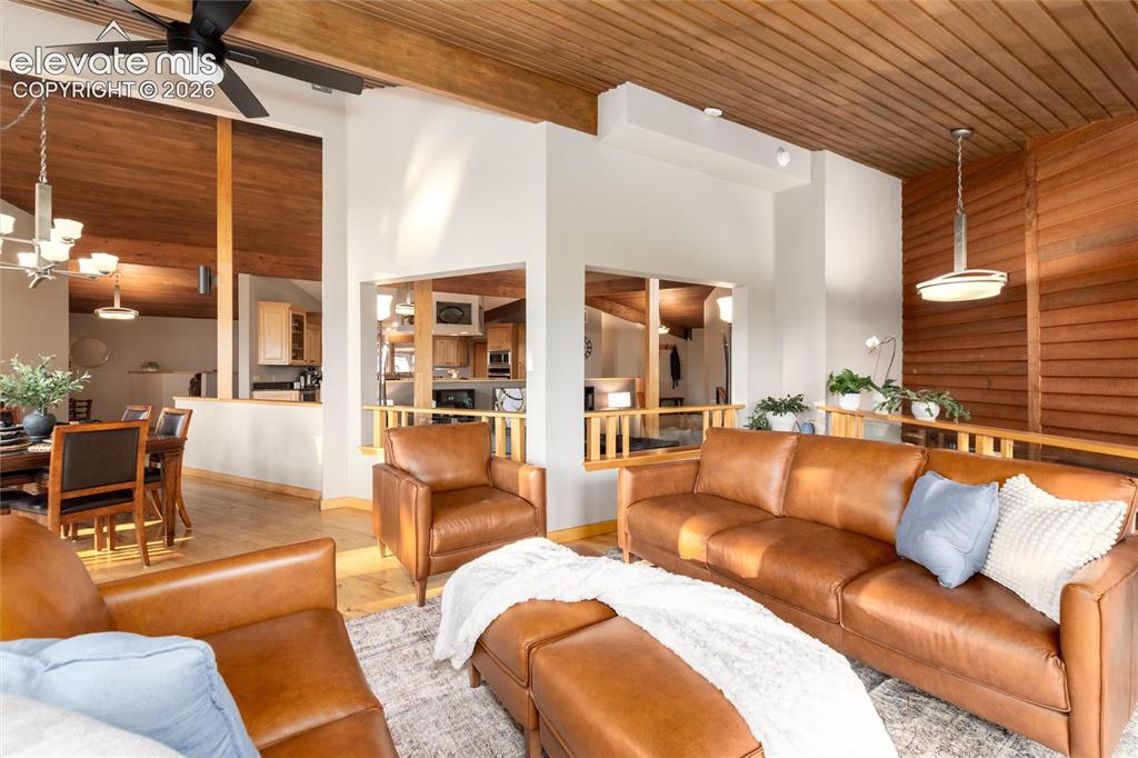 Image 12 of 50: Vaulted wood-paneled ceilings with exposed beams and a ceiling fan