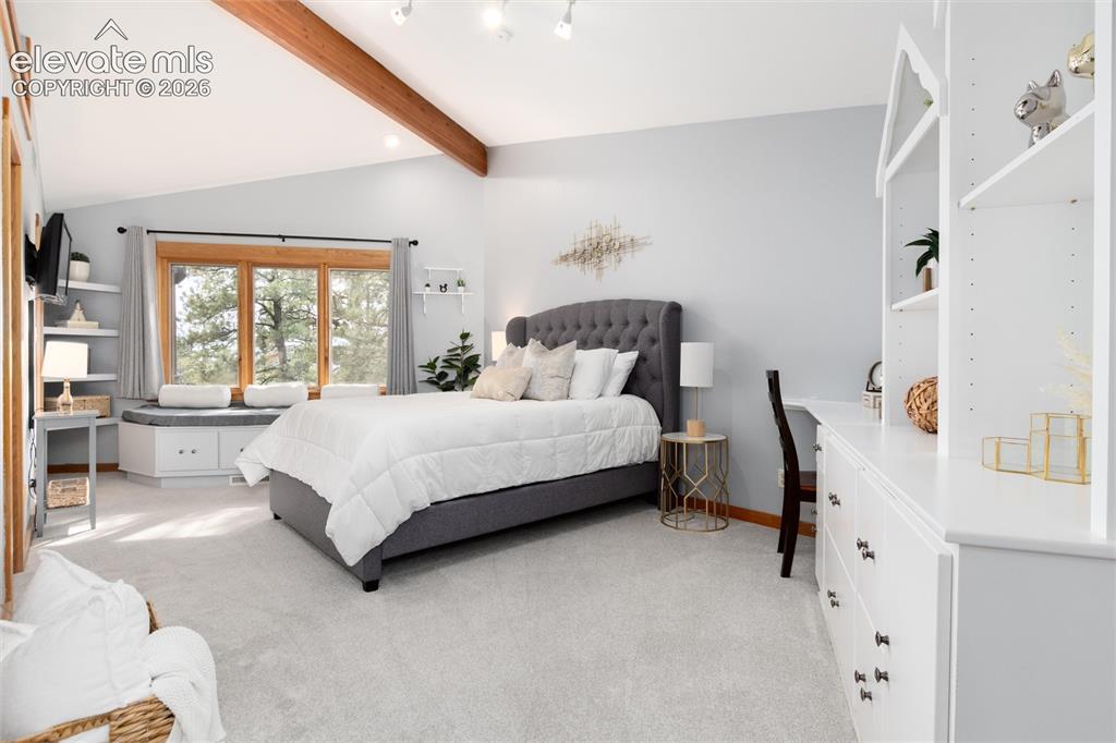 Image 24 of 50: Spacious bedroom with sitting bench in front of window 