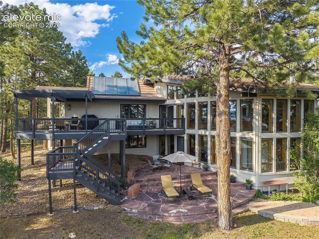 Image 35 of 48: Multi-level exterior featuring extensive window arrays, a spacious elevated