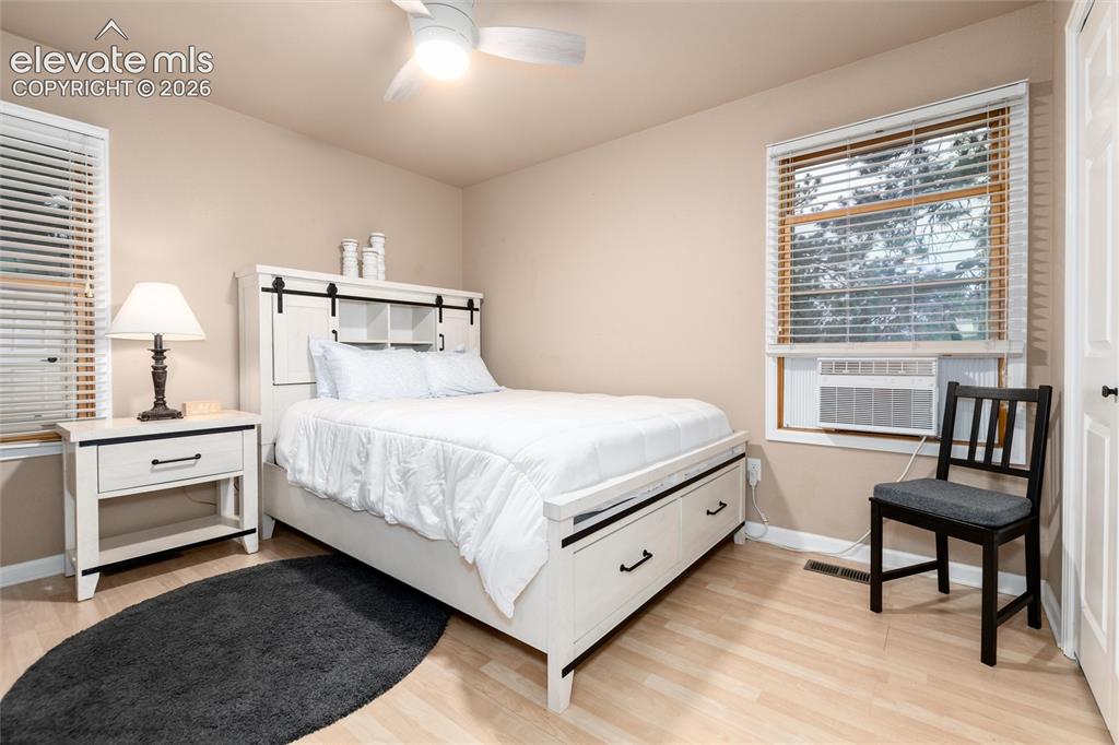Image 39 of 50: Light wood-finish flooring complements neutral wall tones