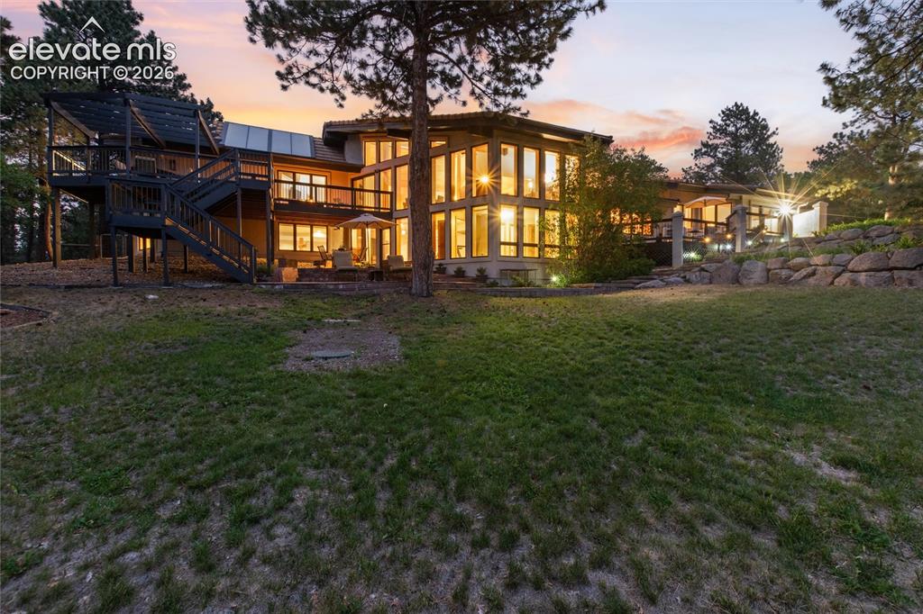 Image 42 of 50: Multi-level dwelling with extensive fenestration, multiple outdoor entertai