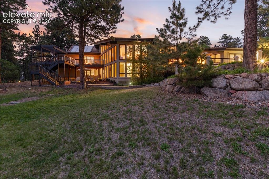 Image 46 of 50: Contemporary multi-level residence featuring extensive window walls, multip